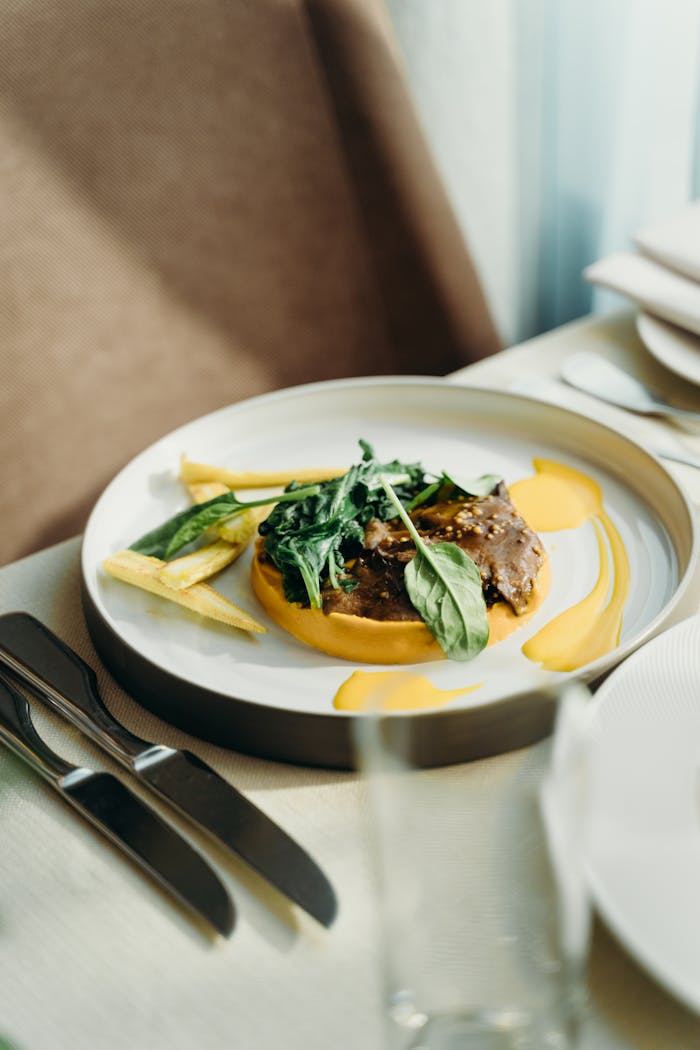 A beautifully plated gourmet dish featuring spinach and sauce, perfect for upscale dining settings.