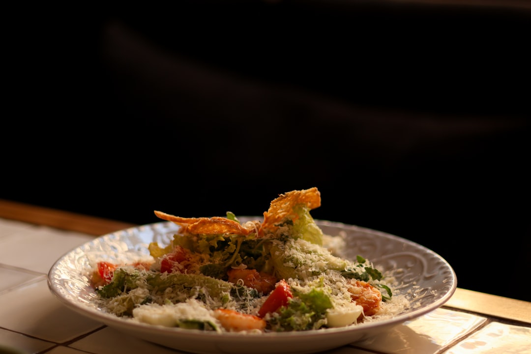 a-white-plate-topped-with-food-on-top-of-a-table-roipgcsdcpq